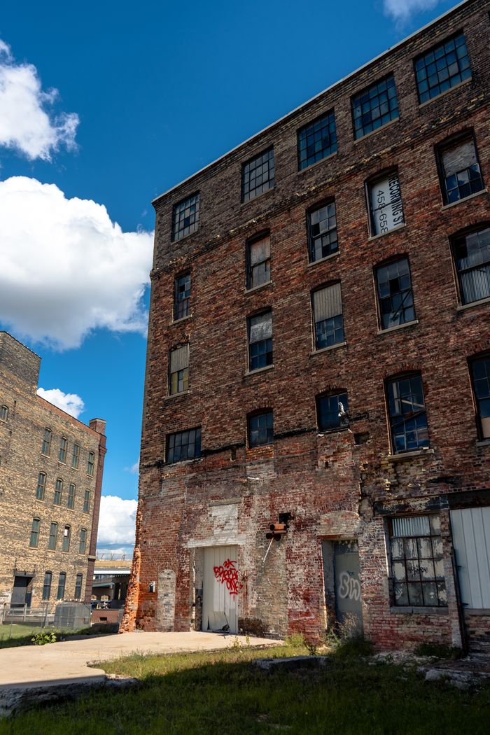 A decaying red brick factory in Grand Rapids, showcasing urban decay and industrial history.